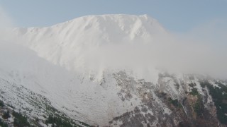 4K aerial stock footage ascending slope approaching snowy summit, Kenai Mountains, Alaska Aerial Stock Footage | AK0001_0526