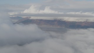 4K aerial stock footage fly by low clouds over Kenai Mountains, Turnagain Arm of the Cook Inlet, Alaska Aerial Stock Footage | AK0001_0532