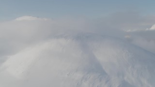 4K aerial stock footage flying by low clouds on the summit, Kenai Mountains, Alaska Aerial Stock Footage | AK0001_0533