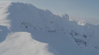 4K aerial stock footage flying by a snowy summit, Kenai Mountains, Alaska Aerial Stock Footage | AK0001_0537