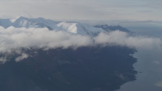 4K aerial stock footage fly by low clouds, Turnagain Arm of the Cook Inlet, and Kenai Mountains, Alaska Aerial Stock Footage | AK0001_0549