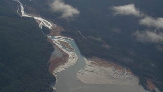 4K aerial stock footage flying by wooded river valley on the shore, Turnagain Arm of the Cook Inlet, Alaska Aerial Stock Footage | AK0001_0550