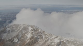 4K aerial stock footage flying by a ridge, blanketed in low clouds, Chugach Mountains, Alaska Aerial Stock Footage | AK0001_0569