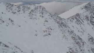 4K aerial stock footage flying by a snowy ridge, Chugach Mountains, Alaska Aerial Stock Footage | AK0001_0571