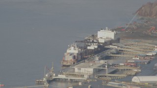 4K aerial stock footage flying by a cargo ship loading, Port of Anchorage, Alaska Aerial Stock Footage | AK0001_0585