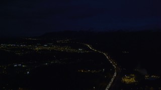 4K aerial stock footage following Glenn Highway, approach Chugach Mountains, Anchorage, Alaska, night Aerial Stock Footage | AK0001_0601