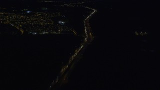 4K aerial stock footage flying over Glenn Highway, approach Chugach Mountains, Anchorage, Alaska, night Aerial Stock Footage | AK0001_0602