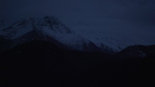 AK0001_0608 - 4K aerial stock footage flying by snow-capped Chugach Mountains, Alaska, sunrise