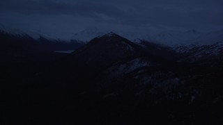 4K aerial stock footage flying by snow-capped Chugach Mountains, Alaska, sunrise Aerial Stock Footage | AK0001_0611