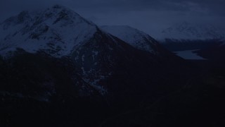 4K aerial stock footage fly by snowy Chugach Mountains, Eklutna Lake, Chugach Mountains, Alaska, sunrise Aerial Stock Footage | AK0001_0612