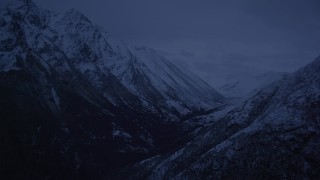 4K aerial stock footage flying by snowy mountains, revealing a valley, Chugach Mountains, Alaska, sunrise Aerial Stock Footage | AK0001_0615