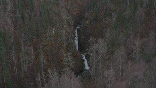 4K aerial stock footage approaching waterfall between wooded hills, Birchwood, Alaska Aerial Stock Footage | AK0001_0631