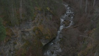 4K aerial stock footage following river at bottom of gorge, reveal wooded hills, Birchwood, Alaska Aerial Stock Footage | AK0001_0632