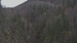 4K aerial stock footage flying above a river gorge, approaching wooded hills, Birchwood, Alaska Aerial Stock Footage | AK0001_0633