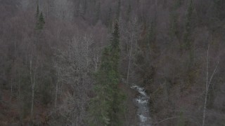 4K aerial stock footage flying over forested hills, tilt down on river, Birchwood, Alaska Aerial Stock Footage | AK0001_0637