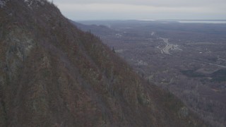 AK0001_0647 - 4K aerial stock footage rounding slope of Chugach Mountains, approach Glenn Highway, Birchwood, Alaska