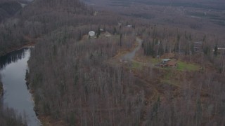 4K aerial stock footage approaching homes atop wooded hills, near river, distant valley, Birchwood, Alaska Aerial Stock Footage | AK0001_0650