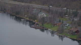 4K aerial stock footage fly by Lower Fire Lake, Glenn Highway, pan to homes, seaplanes, Chugiak, Alaska Aerial Stock Footage | AK0001_0662