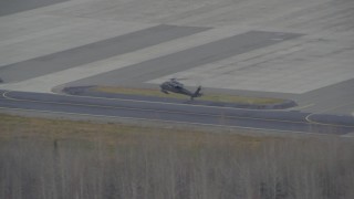 4K aerial stock footage military helicopter landing, 6 parked, Bryant Army Heliport, Anchorage, Alaska Aerial Stock Footage | AK0001_0668