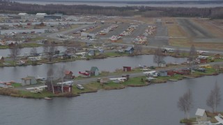 4K aerial stock footage flying by Lake Hood Seaplane Base, Lake Hood Strip, Anchorage, Alaska Aerial Stock Footage | AK0001_0687