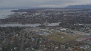 4K aerial stock footage flying over Anchorage West High School, approach Downtown Anchorage, Alaska Aerial Stock Footage | AK0001_0689