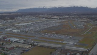 4K aerial stock footage approaching distant snow-capped mountains, Merrill Field, Anchorage Aerial Stock Footage | AK0001_0691