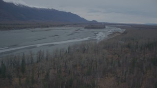 4K aerial stock footage flying along river bank, approaching small island, during winter, Knik River, Alaska Aerial Stock Footage | AK0001_0696