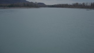 AK0001_0702 - 4K aerial stock footage flying low over river, during winter, Knik River, Alaska