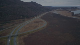 4K aerial stock footage fly over wooded hill, Glenn Highway, during winter, Glenn Highway, Alaska Aerial Stock Footage | AK0001_0706