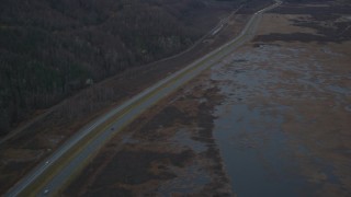 4K aerial stock footage following highway by marshlands, forest, during winter, Glenn Highway, Alaska Aerial Stock Footage | AK0001_0707