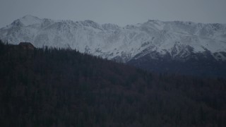 4K aerial stock footage flying by hilltop home, snow-capped Chugach Mountains, Alaska Aerial Stock Footage | AK0001_0713