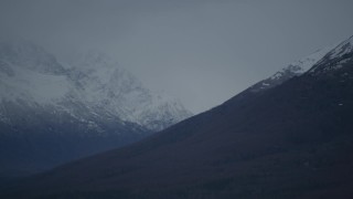 4K aerial stock footage flying by snow-capped peaks, bordering valley, Chugach Mountains, Alaska Aerial Stock Footage | AK0001_0715