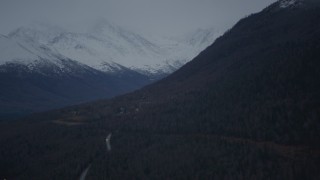 4K aerial stock footage fly by homes at foot of Chugach Mountain, snow-capped peaks, Chugiak, Alaska Aerial Stock Footage | AK0001_0717