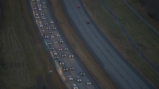 4K aerial stock footage flying low over heavy traffic, during winter, on Glenn Highway, Alaska, twilight Aerial Stock Footage | AK0001_0719