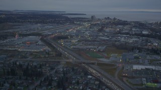 4K aerial stock footage flying by Glenn Highway, reveal Merrill Field, Downtown Anchorage, Alaska, twilight Aerial Stock Footage | AK0001_0724