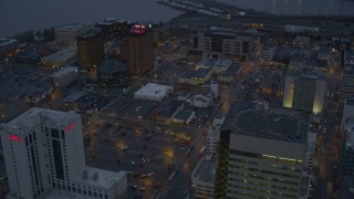 4K aerial stock footage flying by Hotel Captain Cook and office buildings in Downtown Anchorage, Alaska, sunset Aerial Stock Footage | AK0001_0729