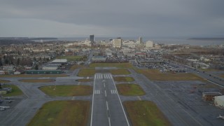 4K aerial stock footage ascend from Merrill Field, fly by Downtown Anchorage, Alaska Aerial Stock Footage | AK0001_0739