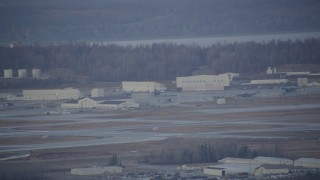 4K aerial stock footage a view of hangars, aircraft in winter, Elmendorf Air Force Base, Anchorage Aerial Stock Footage | AK0001_0741