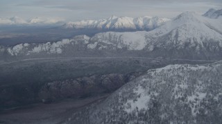 4K aerial stock footage approaching wooded valley and snow-capped Chugach Mountains, Alaska Aerial Stock Footage | AK0001_0772