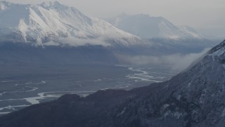 AK0001_0787 - 4K aerial stock footage flying by Knik River Valley, reveal Knik Glacier, snow-capped Chugach Mountains, Alaska