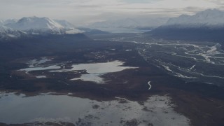 4K aerial stock footage tilt from Gull and Swan Lakes, reveal Knik Glacier, snowy Chugach Mountains, Knik River Valley, Alaska Aerial Stock Footage | AK0001_0790