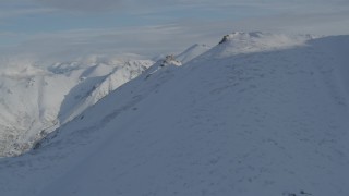 4K aerial stock footage approach summit of snow-covered Chugach Mountains, Alaska Aerial Stock Footage | AK0001_0797