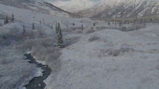 4K aerial stock footage flying low beside river, frosty valley, snowy Chugach Mountains, Alaska Aerial Stock Footage | AK0001_0803