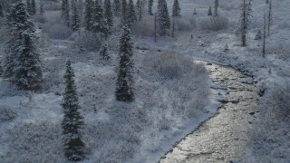 4K aerial stock footage flying over river and snowy trees, Chugach Mountains, Alaska Aerial Stock Footage | AK0001_0809