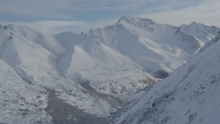 4K aerial stock footage flying by snowy mountain slope, Chugach Mountains, Alaska Aerial Stock Footage | AK0001_0812