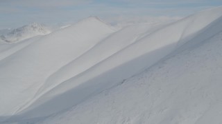 4K aerial stock footage flying low over snowy slopes, Chugach Mountains, Alaska Aerial Stock Footage | AK0001_0815