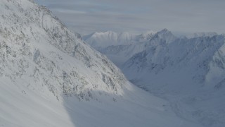 4K aerial stock footage flying beside snowy valley, mountain slope, Chugach Mountains, Alaska Aerial Stock Footage | AK0001_0828