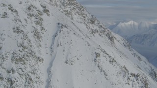 4K aerial stock footage approaching rocky, snowy slope, Chugach Mountains, Alaska Aerial Stock Footage | AK0001_0830