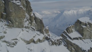 4K aerial stock footage flying along rocky slope, over snowy peak, valley, Chugach Mountains, Alaska Aerial Stock Footage | AK0001_0832