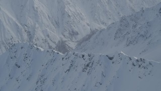 4K aerial stock footage approaching snowy range, tilt down to slope, Chugach Mountains, Alaska Aerial Stock Footage | AK0001_0840